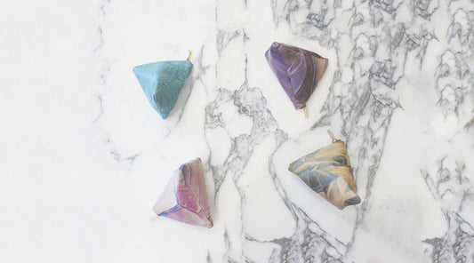 All colours of TAT Mini Illusory Pyramid leather pouches arranged together