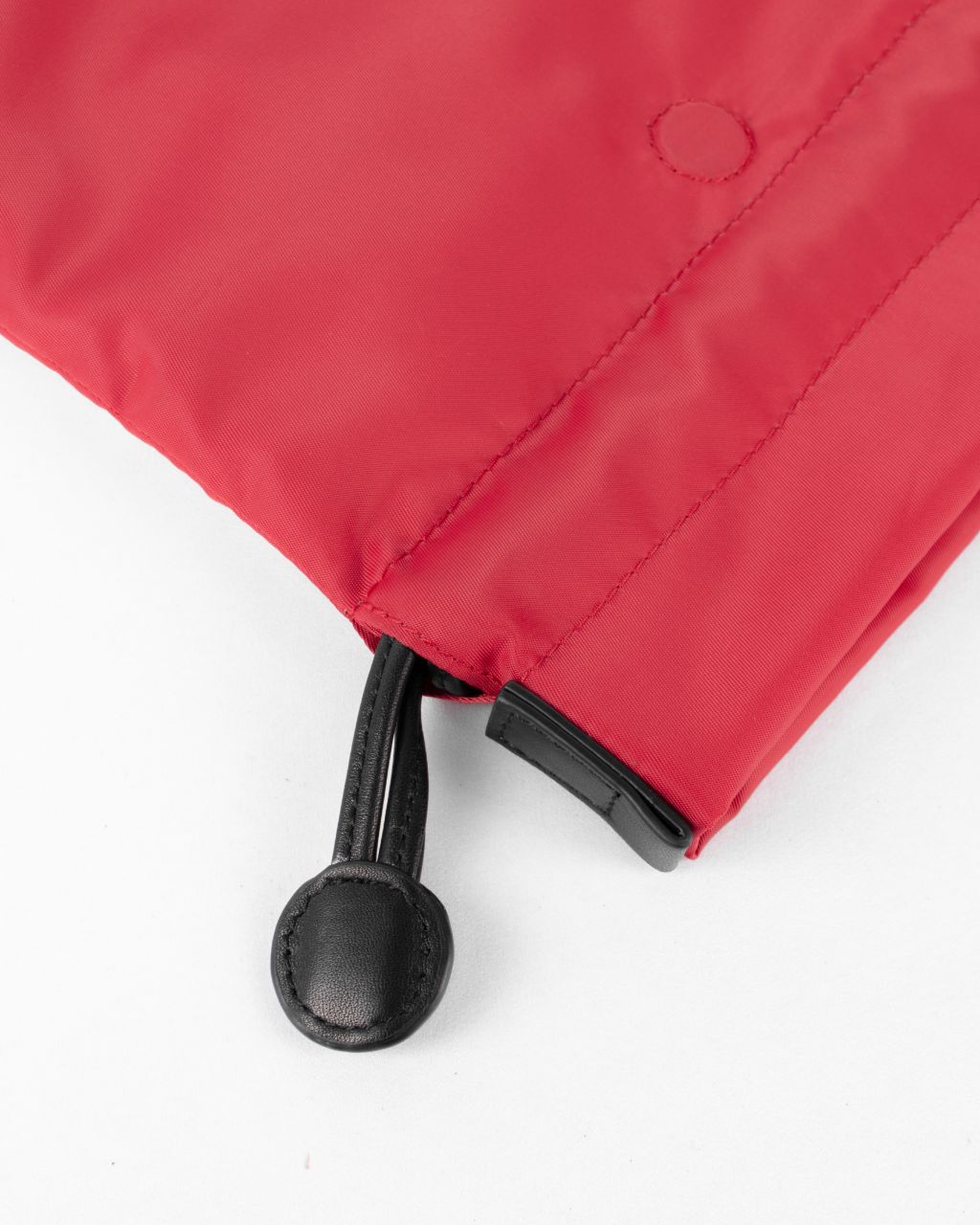beans bag in red water repellent nylon and leather close up