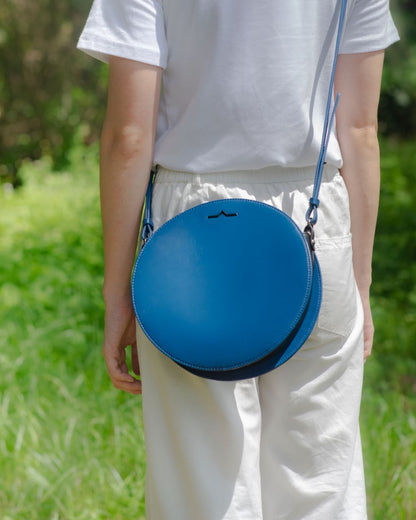 Blue circle Napa leather shoulder crossbody on model front