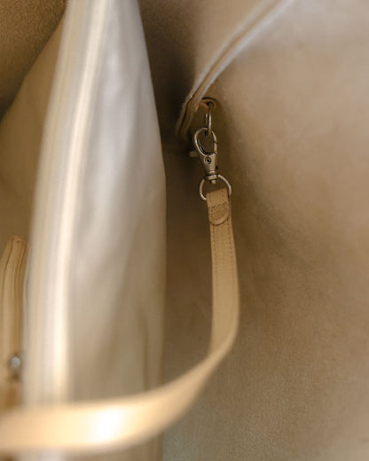 close up of hook of attachable leather zip pouch with strap 