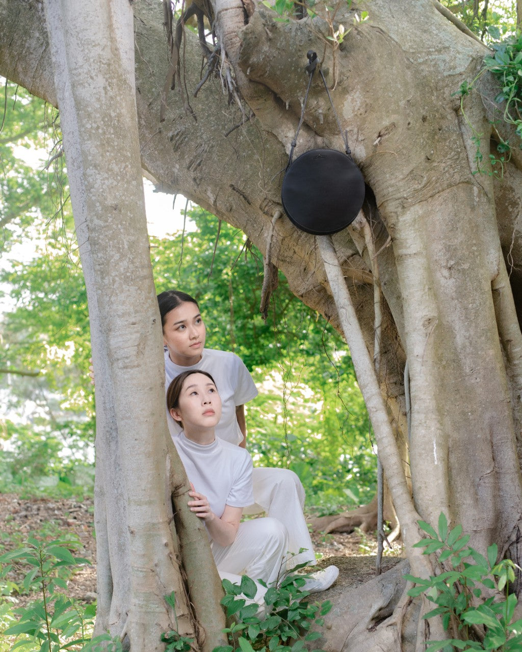 girls looking at black moon in the forest