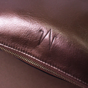 TAT_normcore_2tone_clutch_14582_bronze bk front embossed logo close up