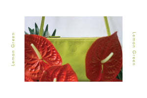 TAT_normcore_crossbody_14632_lemongreen_front styling photos with flowers embossed logo