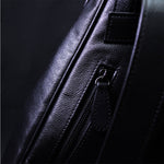TAT_whysoserious_triangle backpack_black back detail with leather zipper puller