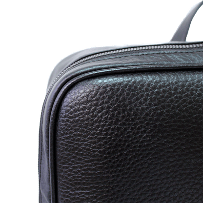 black square leather backpack leather close up 