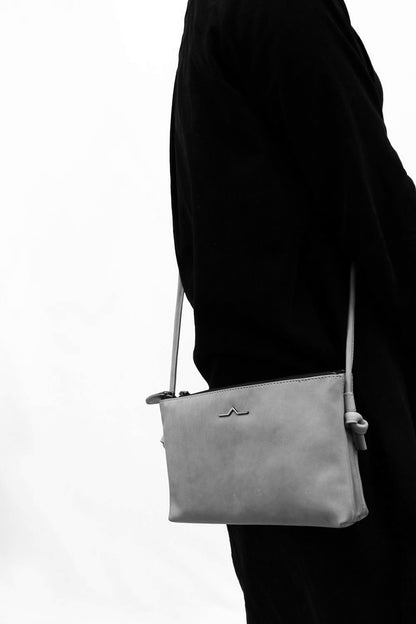 153 cm height model wering leather crossbody