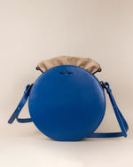 blue round cow leather crossbody with beige nylon beans bag set